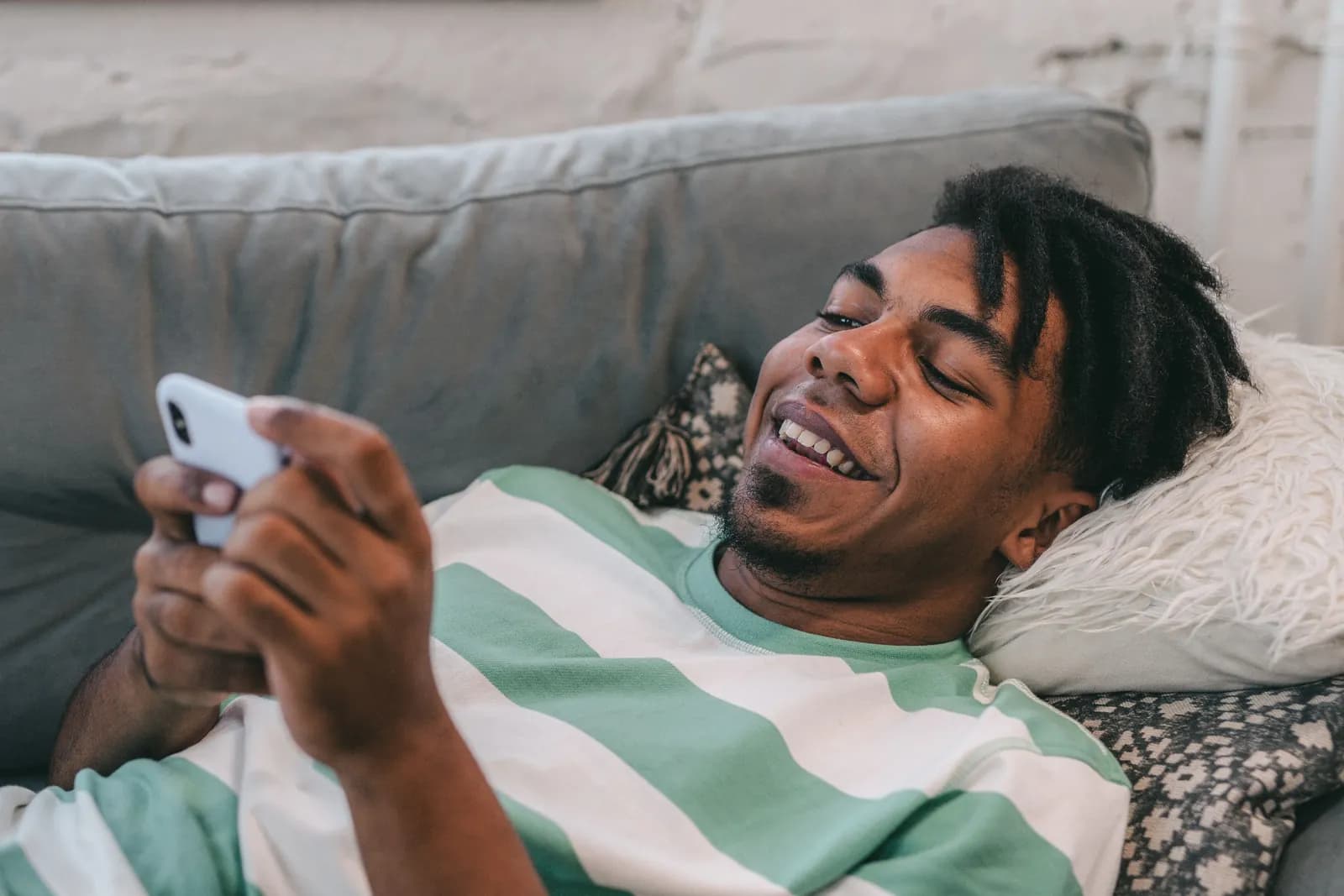 A patient smiling at a message on his phone