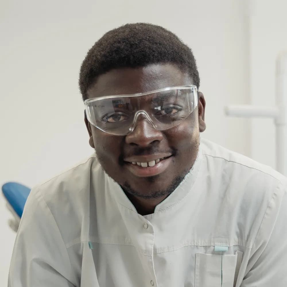 A dentist smiling in his surgery