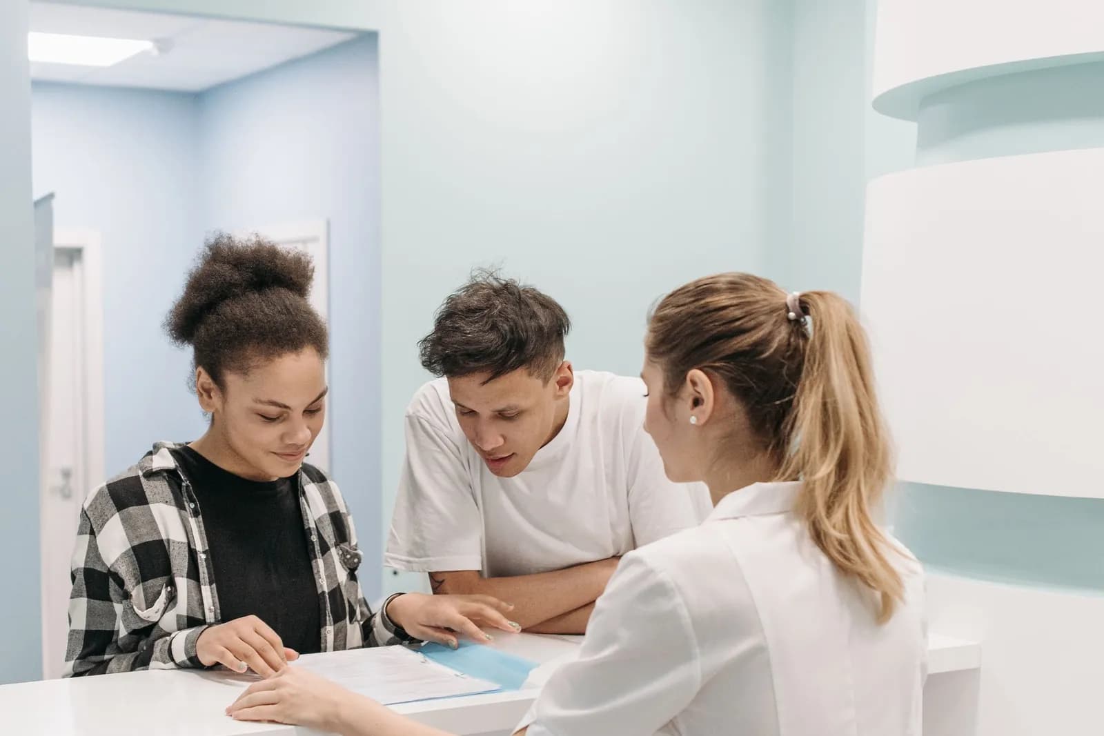 Practice staff going through a booking together at the front desk